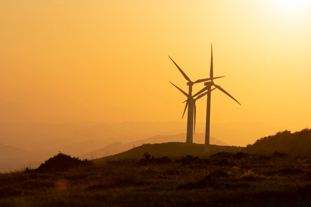 wind generators in the mountains at sunsetの写真素材