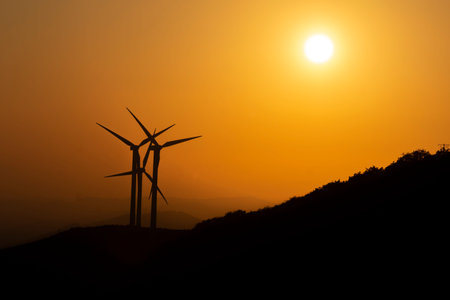 eolic wind generators spinning in the mountains at sunset. High quality photo