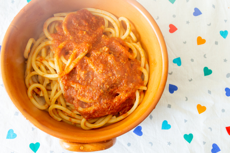 Homemade spaghetti with guitar, seasoned with cuttlefish sauce, to eat at the table for lunch or dinner.の写真素材