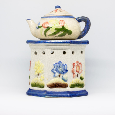 A particular ceramic candlestick made of three pieces. Floral-themed work in blue, red, yellow colors.の写真素材