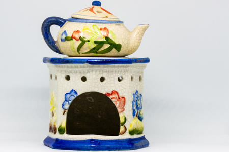 A particular ceramic candlestick made of three pieces. Floral-themed work in blue, red, yellow colors.の写真素材
