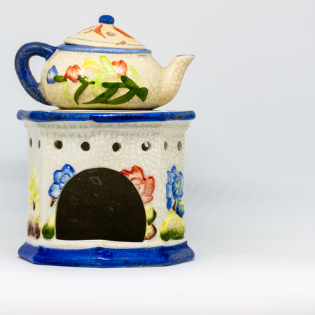 A particular ceramic candlestick made of three pieces. Floral-themed work in blue, red, yellow colors.の写真素材