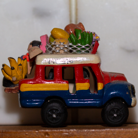 A small toy van colored yellow, red and blue, a memory of a journey.の写真素材