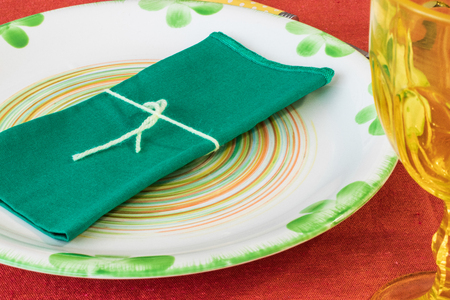Sunday at home waiting for guests. A table set with plates, glasses and colored cutlery.の写真素材
