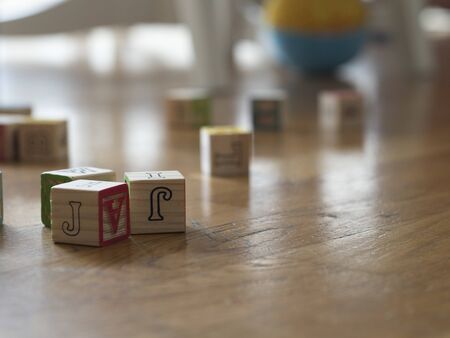 Morning at home with the family to play with the children. Wooden cubes scattered across the living room floor.の写真素材