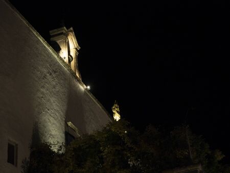 Wedding day in Martina Franca, a rustic place surrounded by greenery in southern Italy. An old bell tower of a little church illuminated for the event.の写真素材