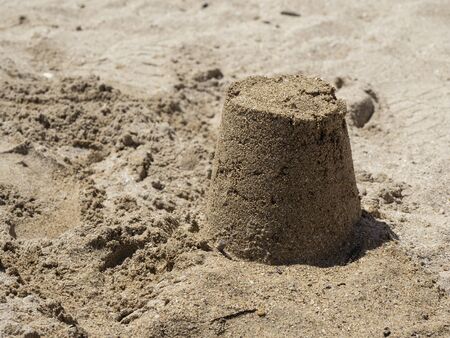 One morning on the beach with the children. A sand castle made by children on a beach in Bari, in southern Italy.の写真素材