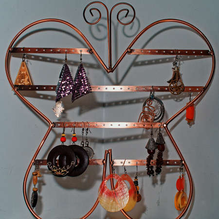 Objects for decorating a girl's bedroom. A metal butterfly hanging on the wall as a jewelry box for large earrings.の写真素材