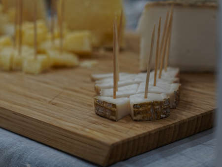 Prepare an appetizer to serve for dinner time at home. A typical cheese of Italian cuisine cut into small squares.の写真素材