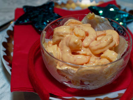 Dinner time on Christmas Eve with the family. Shrimp in pink sauce served on a crystal glass as an appetizer.の写真素材