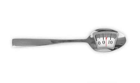 Metal spoon with weight scaleの写真素材