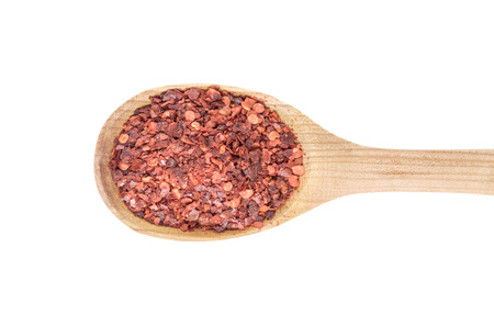 Red pepper in spoon on white backgroundの写真素材