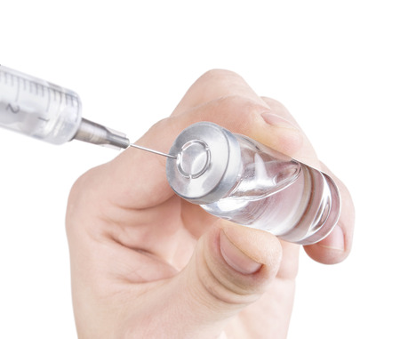 Doctor hand holding insulin vial, syringe and getting ready for injection isolated on a white backgroundの写真素材