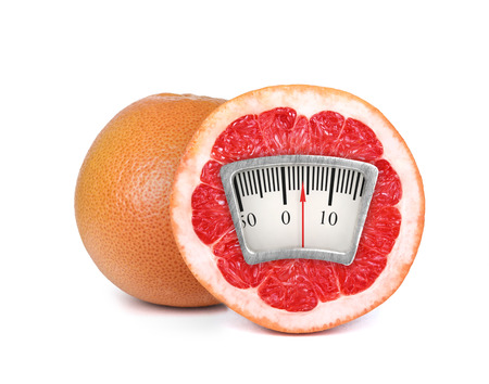 Weight scale on an orangeの写真素材