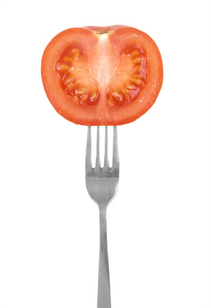healthy looking tomato on a fork. Isolated on whiteの写真素材