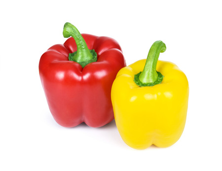 Red and yellow sweet peppers isolated on white backgroundの写真素材