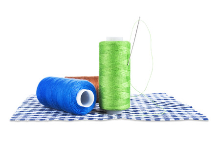  Bobbins with needle isolated on whiteの写真素材