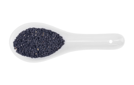 cumin seeds in spoon isolated on white backgroundの写真素材