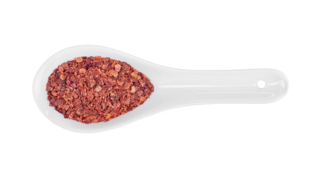 red pepper on white porcelain spoonの写真素材