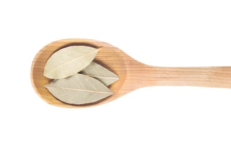 Bay leaves onto wooden spoonsの写真素材
