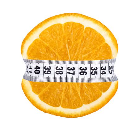 Orange slice with measurement isolated on whiteの写真素材