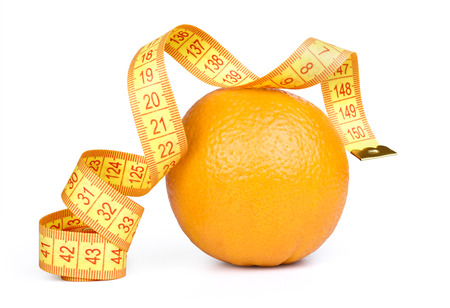 Orange fruit with tape measure on white backgroundの写真素材