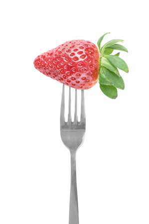 Fresh big strawberry on a fork against white backgroundの写真素材