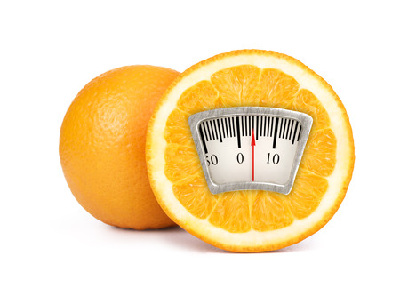 Weight scale on an orangeの写真素材