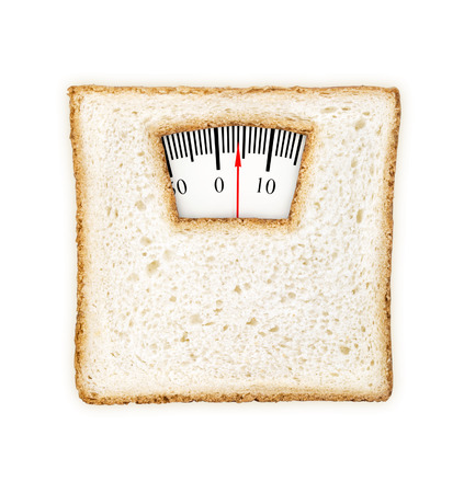 Imaginary weighing scales made of bread slice isolated on white backgroundの写真素材