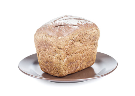 Loaf of bread on plate. Isolated on white.の写真素材