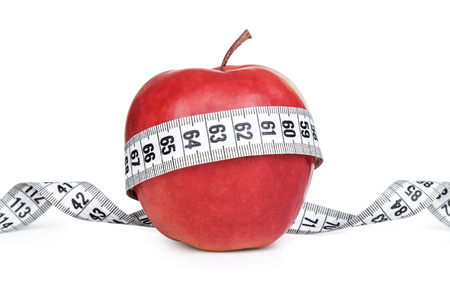 apple with measure tape on white backgroundの写真素材