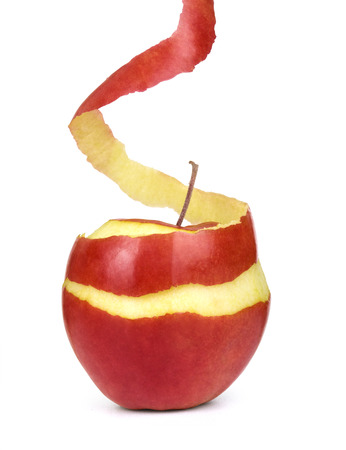 apple with peeled skin on white backgroundの写真素材