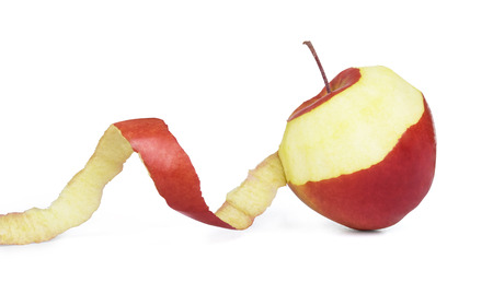 apple with peeled skin on white backgroundの写真素材