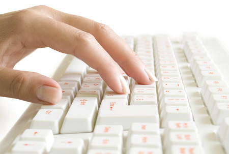 hand on the computer keyboard isolated on whiteの写真素材