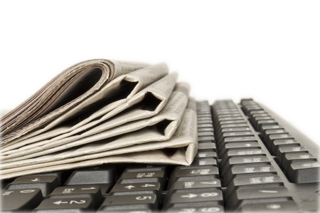 computerand newspapers isolated in whiteの写真素材