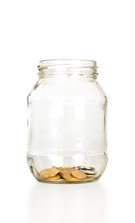 Glass bank for tips with money isolated on whiteの写真素材