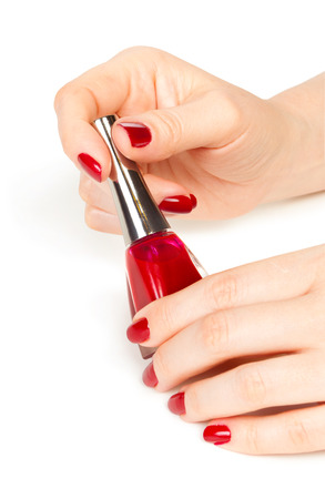 woman applying red nail polishの写真素材