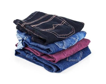 Many different colored jeans on whiteの写真素材