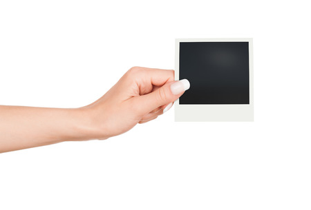 Hand holding blank Instant Photo on white backgroundの写真素材