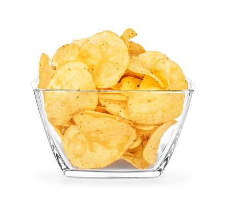 potato chips in a glass bowl on an isolated white backgroundの写真素材