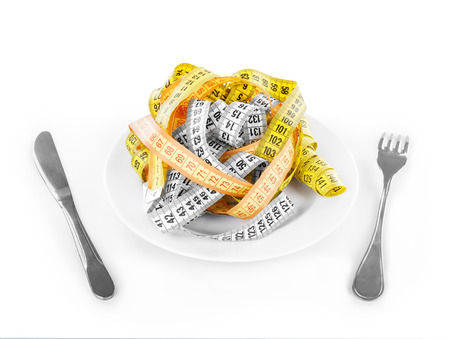measuring tapes on plate isolated on whiteの写真素材