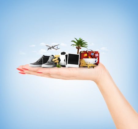 Travel concept. Hand holding atribute of travel and holiday.の写真素材