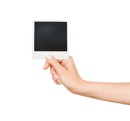 Hand holding blank Instant Photo on white backgroundの写真素材