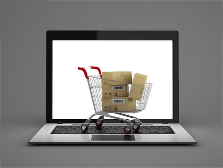 Online shopping concept. Shopping Cart with Boxes over Laptop on a white backgroundの写真素材