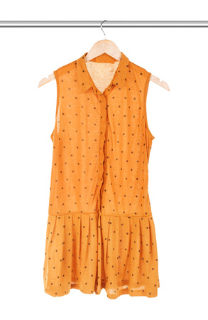 yellow dress on a hanger on a white backgroundの写真素材