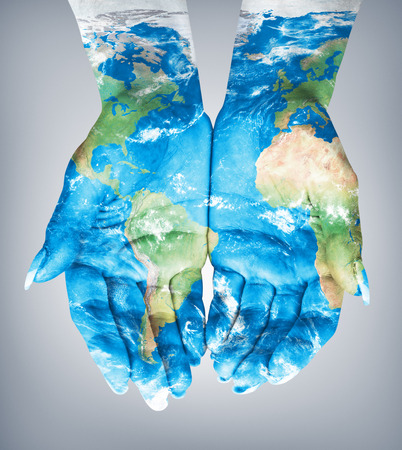 Map painted on hands.Concept of having the world in our handsの写真素材