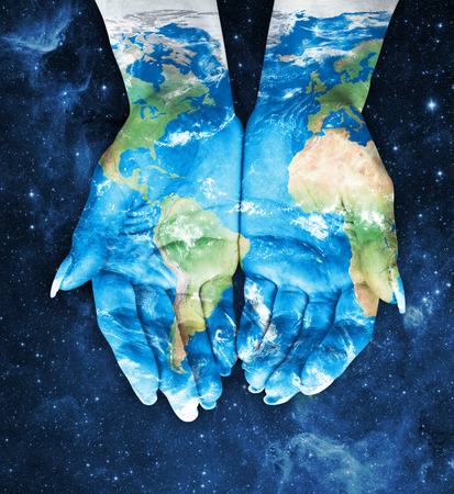 Map painted on hands.Concept of having the world in our hands in spaceの写真素材