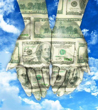 Hand coated in dollar banknotes. Isolated on whiteの写真素材