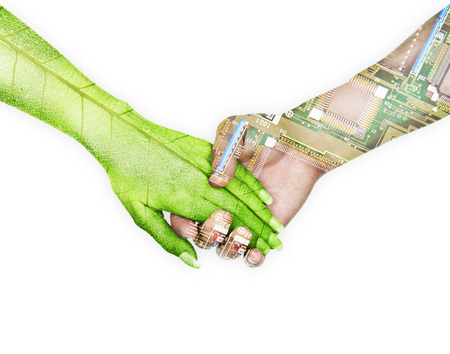 Nature and electronics holding hands in sky backgroundの写真素材