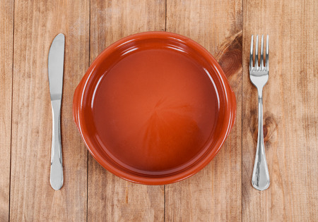 plate, knife and fork on wooden backgroundの写真素材